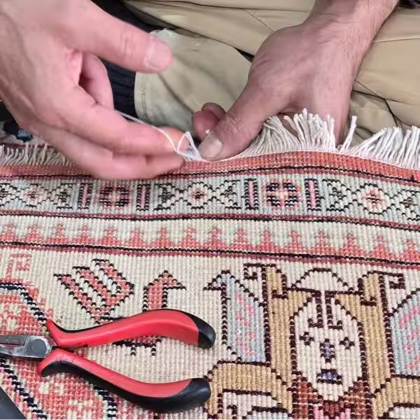 Professional blocking of Persian and Oriental rug fringe in Auckland to prevent unraveling and secure the edges through expert stabilization and restoration techniques by The Rug Guru
