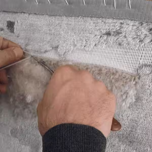 Before and after comparison of worn rug pile restoration showing professional repair results in Auckland