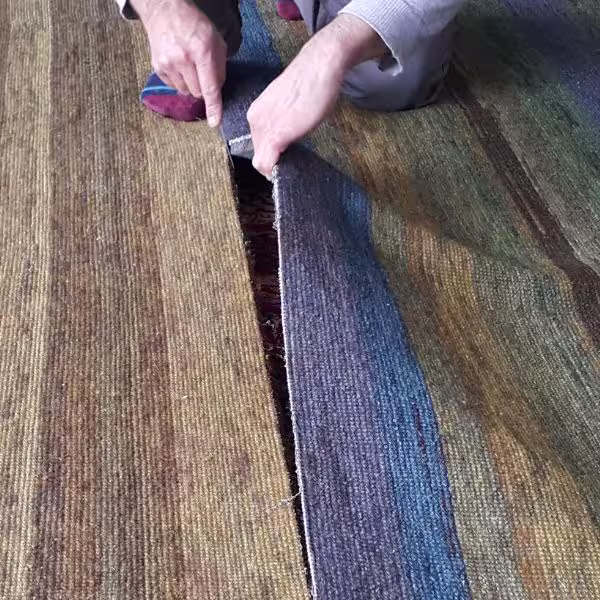 Before rug resizing and reshaping of handmade rug for custom fit in Auckland workshop