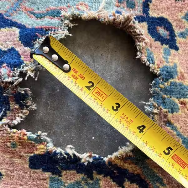 Before rug reweaving repair of damaged Persian rug showing structural reconstruction in Auckland workshop