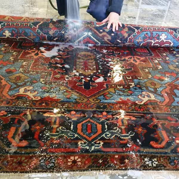 Hand washing Persian rugs in Auckland using conservation-grade rug cleaning techniques at The Rug Guru workshop