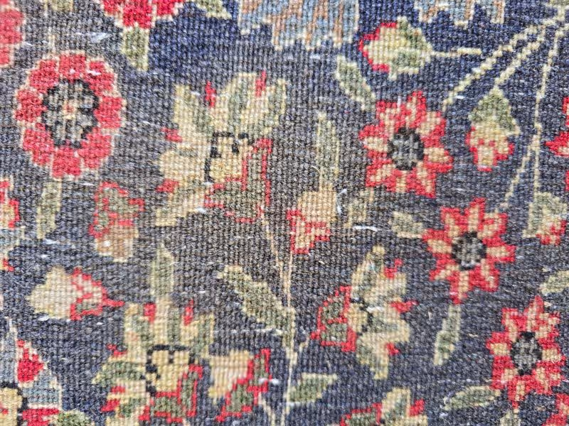 Hand controlled colour rebalancing during antique rug restoration in Auckland adjusting faded tones in Persian rug fibres at The Rug Guru