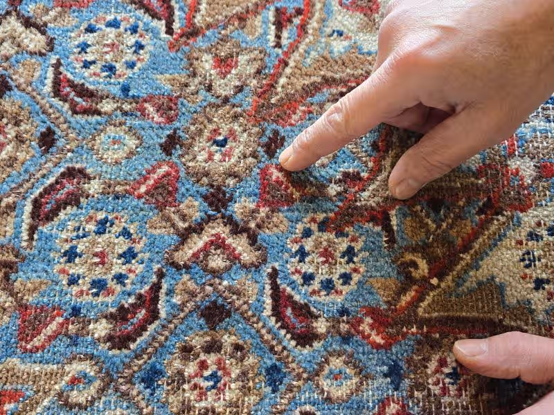 Antique rug restoration Auckland fibre assessment at The Rug Guru evaluating wool and silk condition before colour restoration treatment