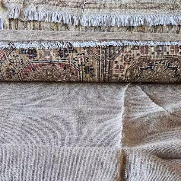 Breathable protective wrap applied to rug for moisture and dust control during storage