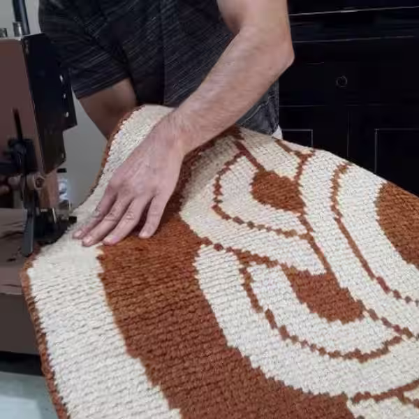 Professional carpet overlocking in Auckland showing reinforced edge stitching on cut carpet for fray prevention