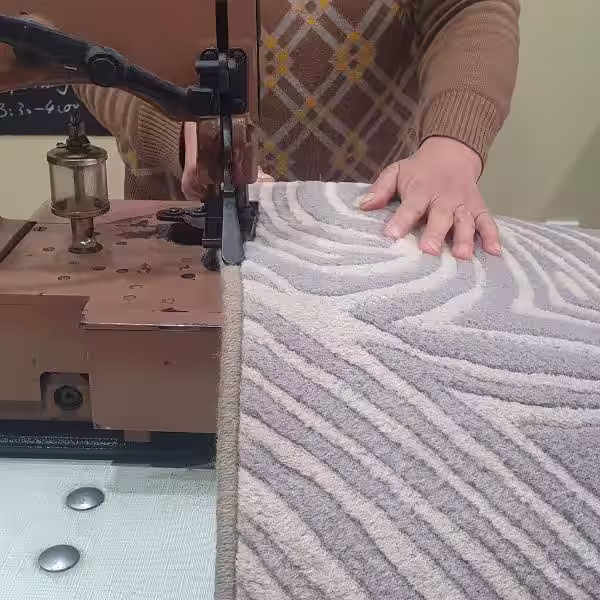 Carpet overlocking applied to wool and synthetic rug edges for durable perimeter reinforcement