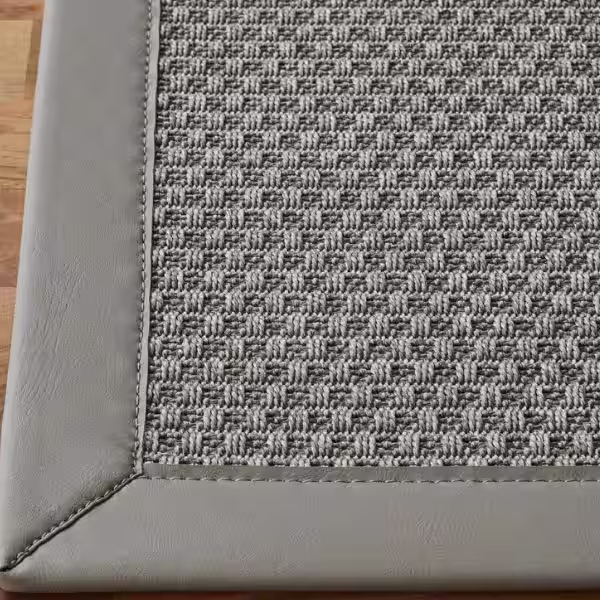 Completed leather marine edging installed on rug border for durable custom finishing by The Rug Guru