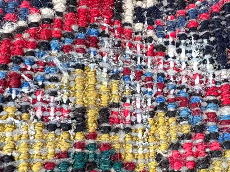 Professional repair and restoration of a moth-damaged handmade rug after fibre loss and insect infestation