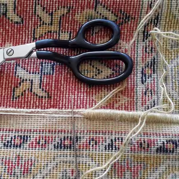 Finished handmade rug border showing clean hand binding and reinforced edge detailing for durability