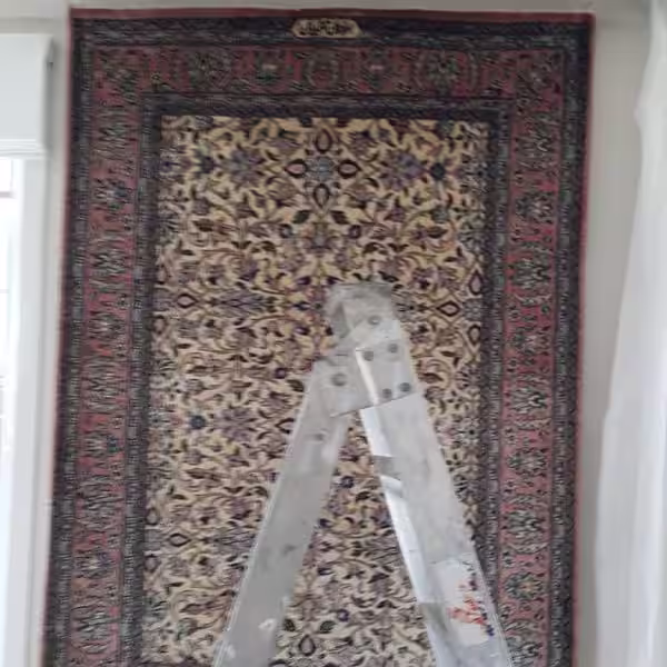 Rug wall hanging installation in Auckland using rod and bracket support system for vertical rug display