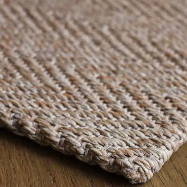 Sisal rug with natural edge finishes and custom border edging detail