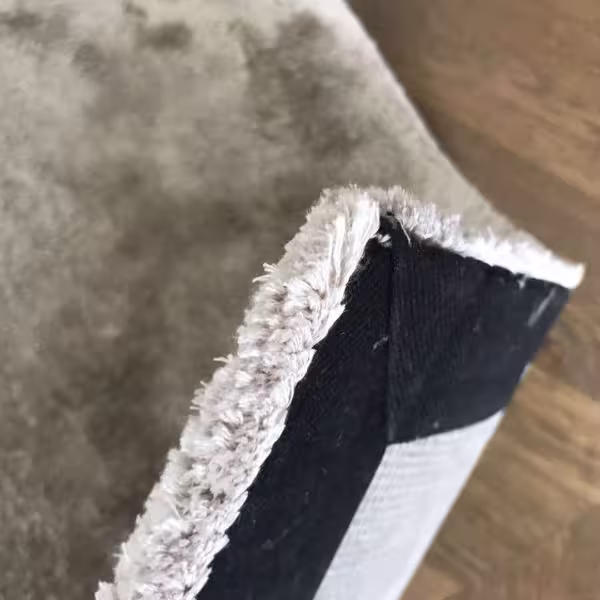 Tape edging used on shaggy rug to create a hidden border finish without visible edging by The Rug Guru
