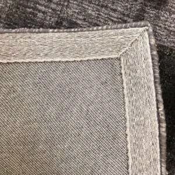 Tufted rug with reinforced edge binding and border finishing for added durability by The Rug Guru